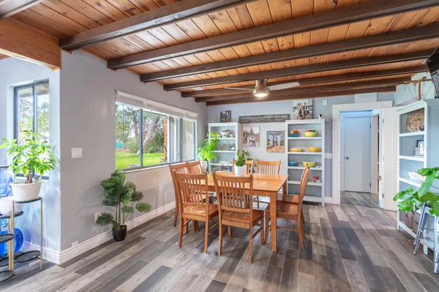 a kitchen that has a lot of cabinets in it and wooden floors