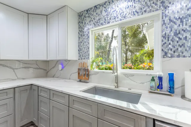 a kitchen with stainless steel appliances a refrigerator sink and cabinets