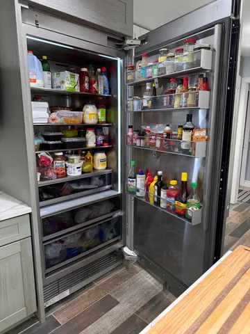 a bathroom with double vanity and a mirror