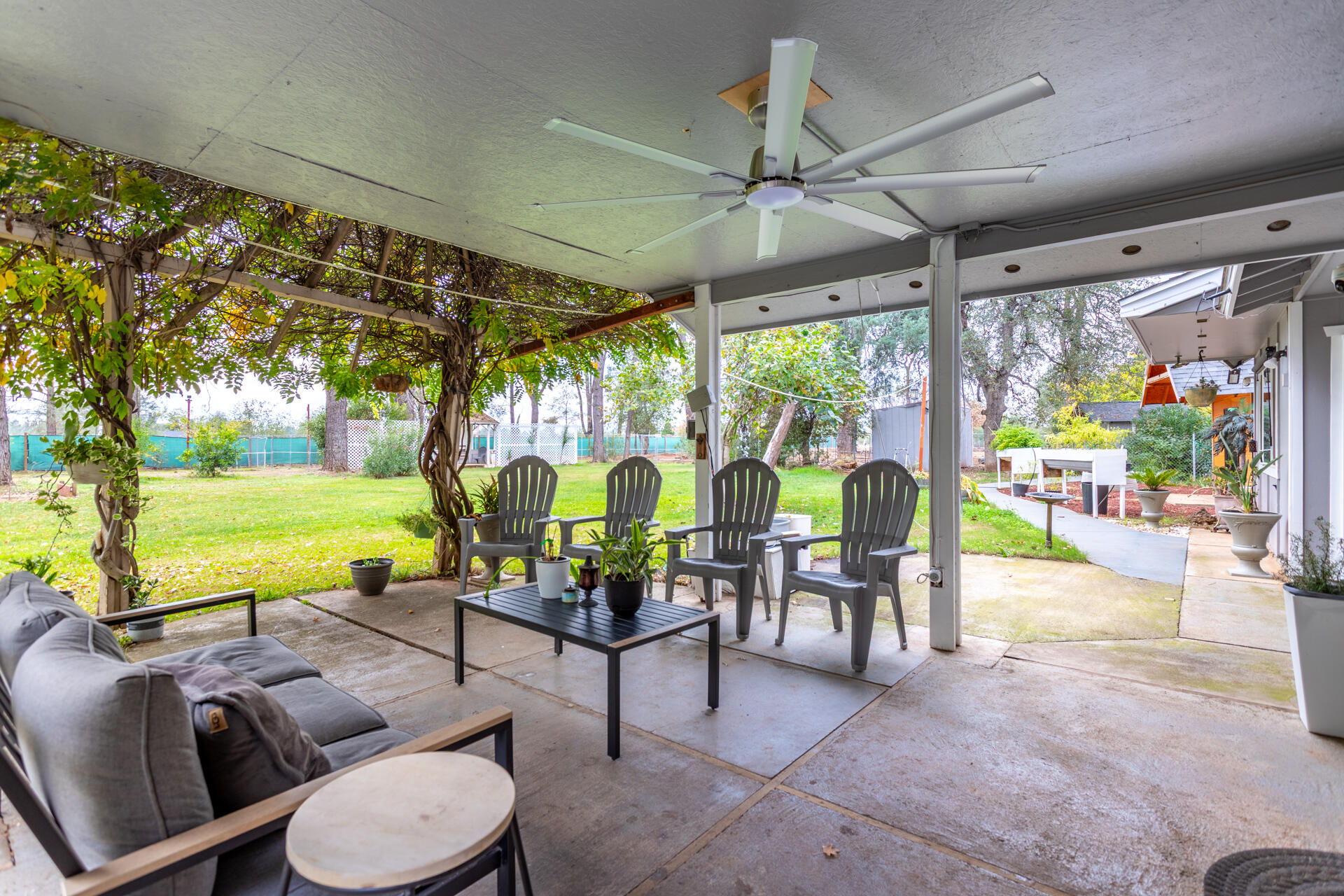 6188 Happy Valley Road Anderson, CA 96007 - Photo 31 of 58 a living room with patio furniture and a floor to ceiling window