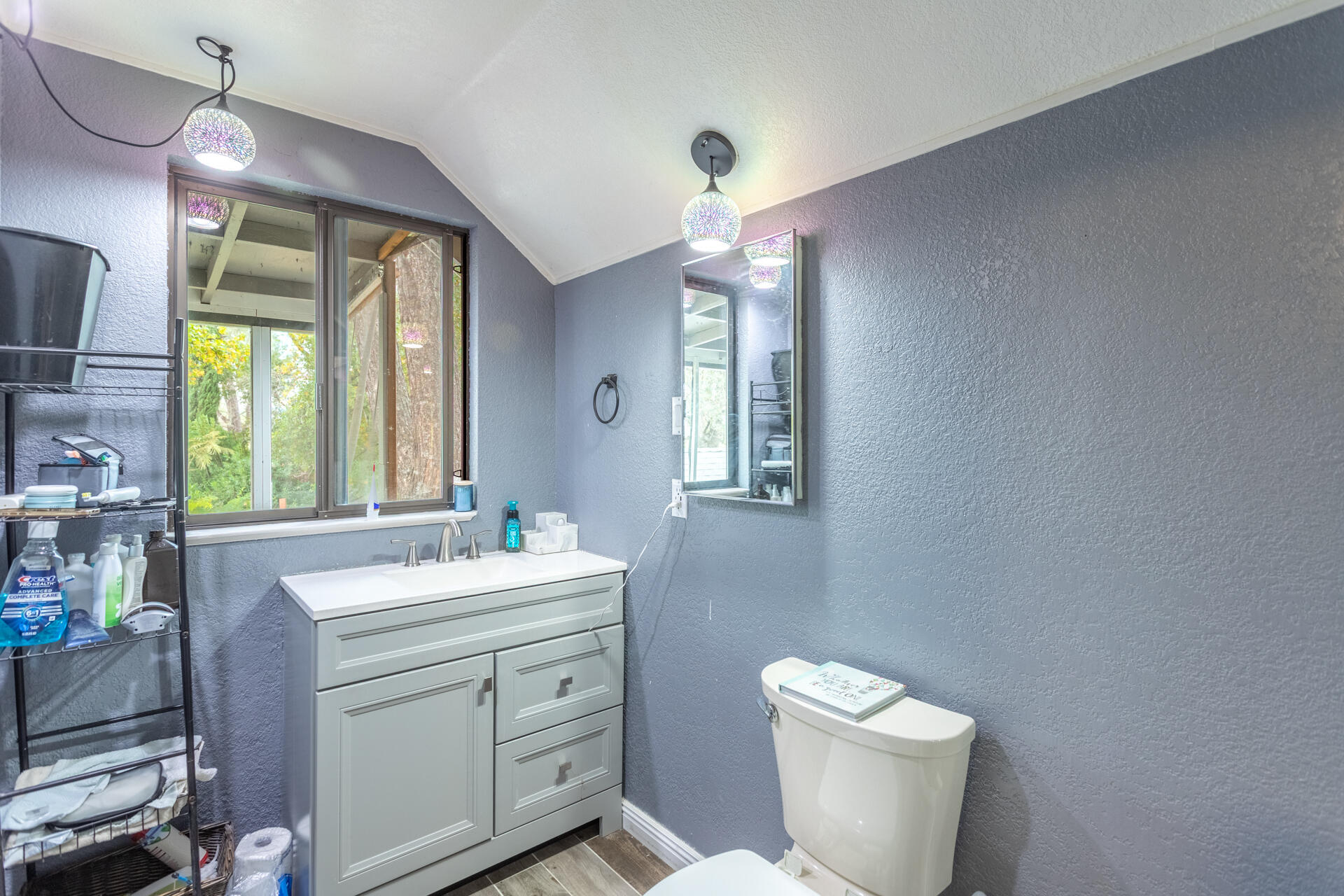6188 Happy Valley Road Anderson, CA 96007 - Photo 43 of 58 a bathroom with a toilet sink and mirror