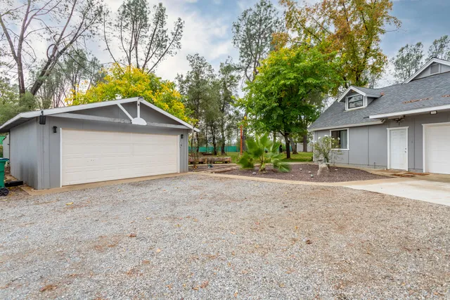 a view of a house with a yard and garage