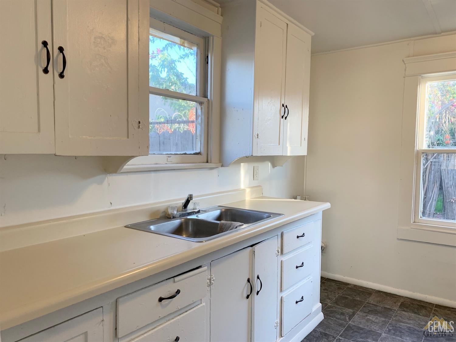 Undisclosed Address Bakersfield, CA 93304 - Photo 11 of 15 a kitchen with appliances cabinets and a sink