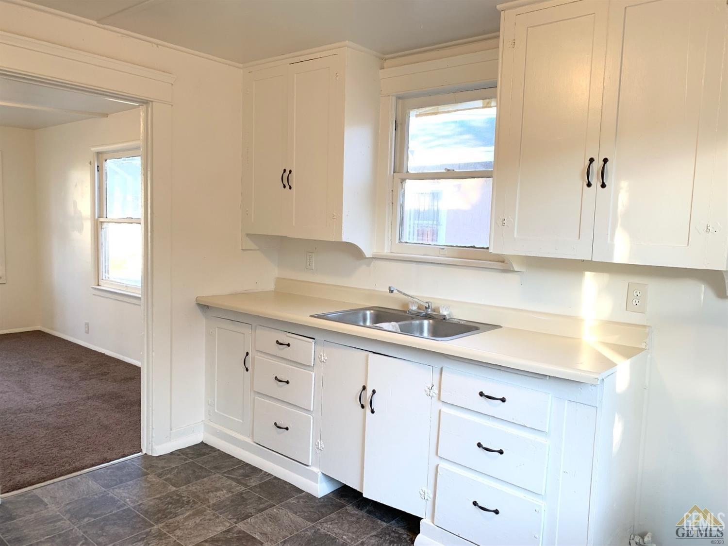 Undisclosed Address Bakersfield, CA 93304 - Photo 12 of 15 a kitchen with cabinets appliances a sink and a window