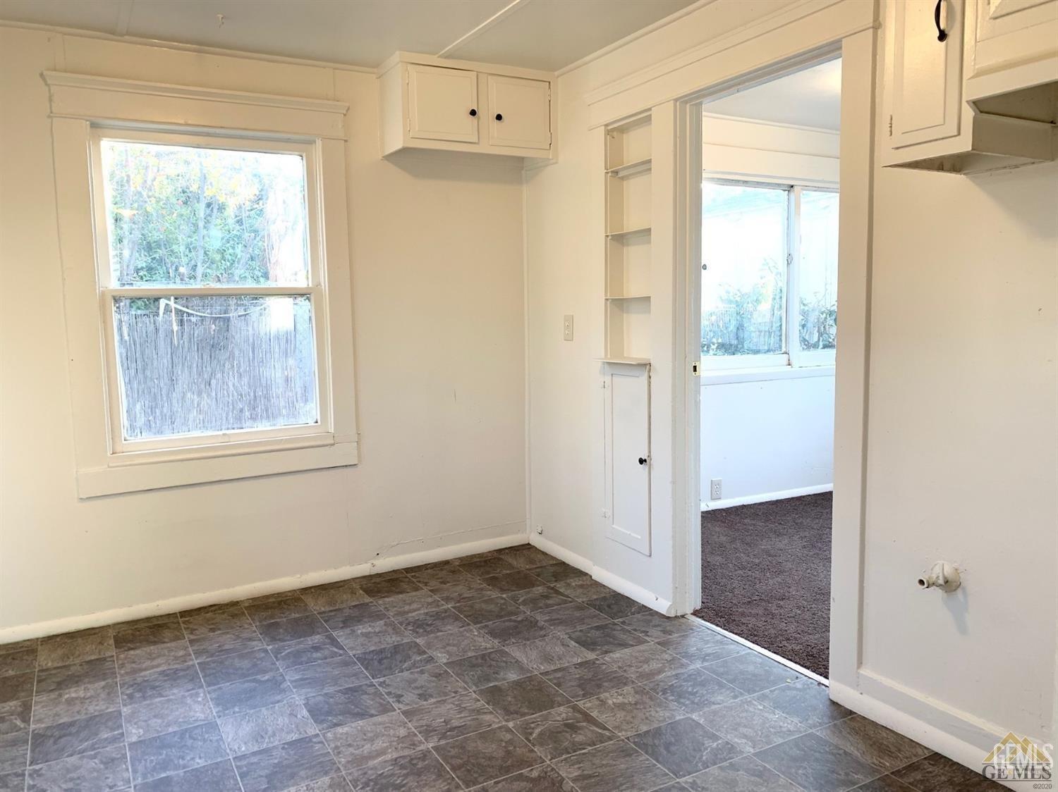 Undisclosed Address Bakersfield, CA 93304 - Photo 13 of 15 a view of an empty room with wooden floor and a window