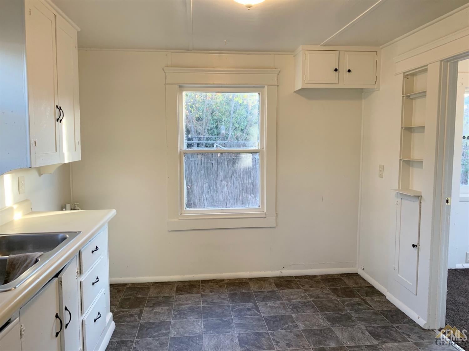 Undisclosed Address Bakersfield, CA 93304 - Photo 14 of 15 a view of a kitchen that shows a sink and dishwasher with wooden floor