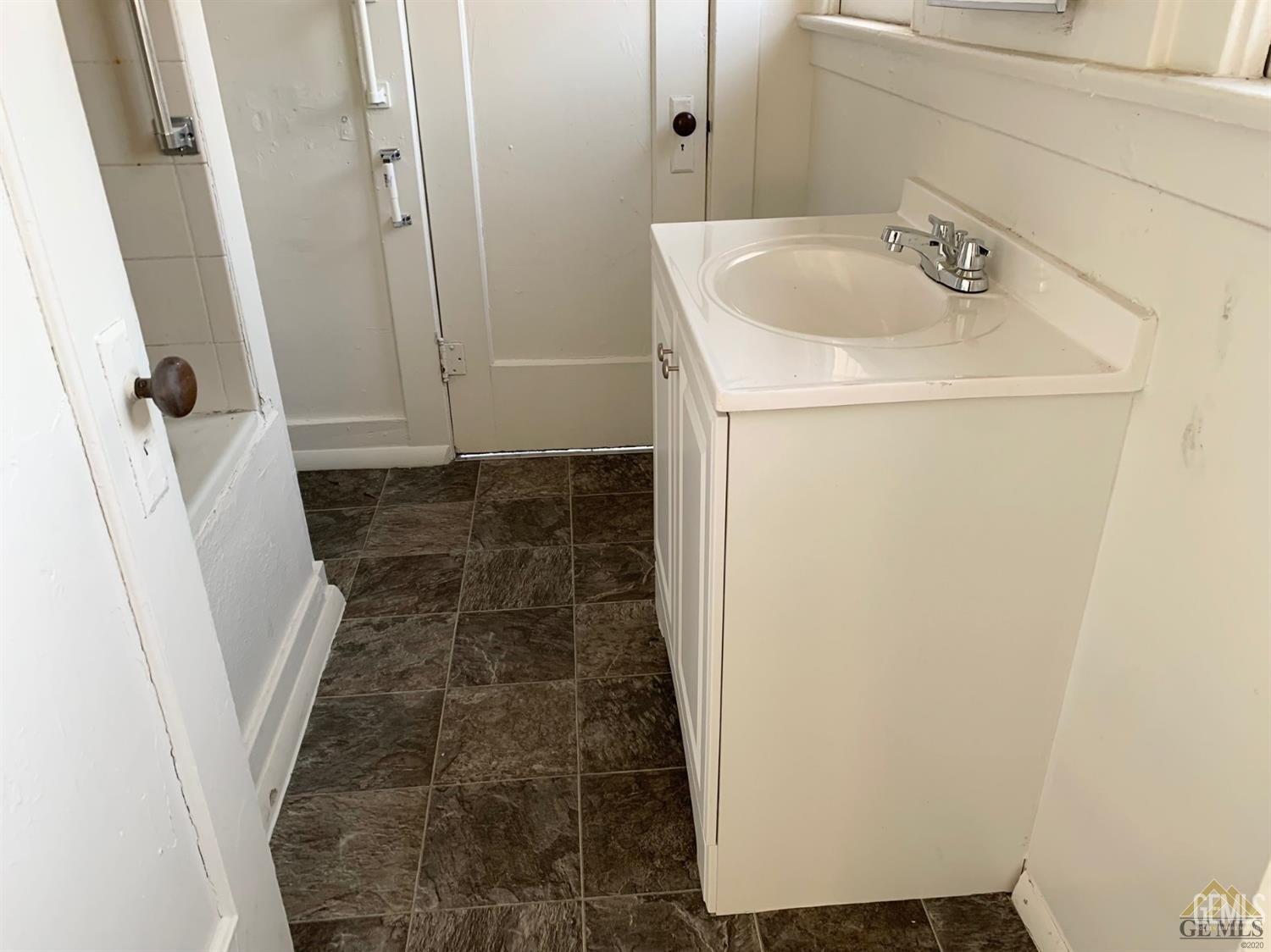 Undisclosed Address Bakersfield, CA 93304 - Photo 10 of 15 a bathroom with a sink and a mirror