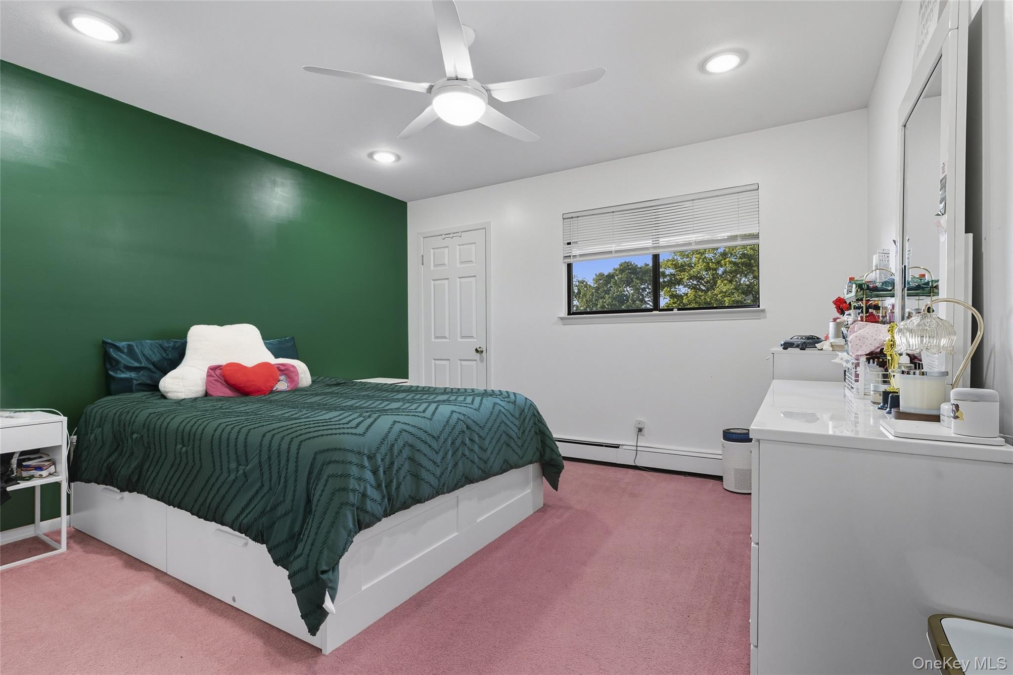 258 Half Hollow Road Dix Hills, NY 11746 - Photo 21 of 45 a bedroom with a bed and a chandelier