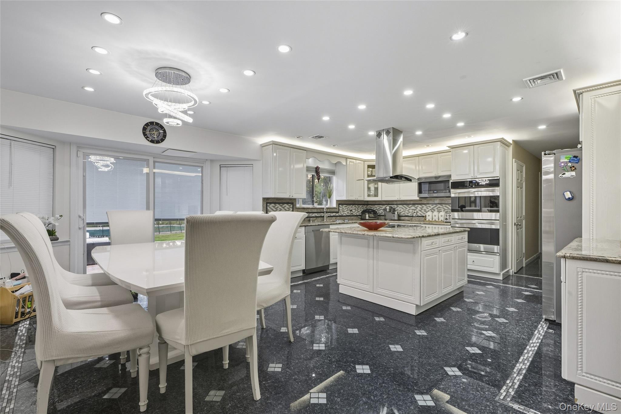258 Half Hollow Road Dix Hills, NY 11746 - Photo 30 of 45 a large kitchen with a table and chairs