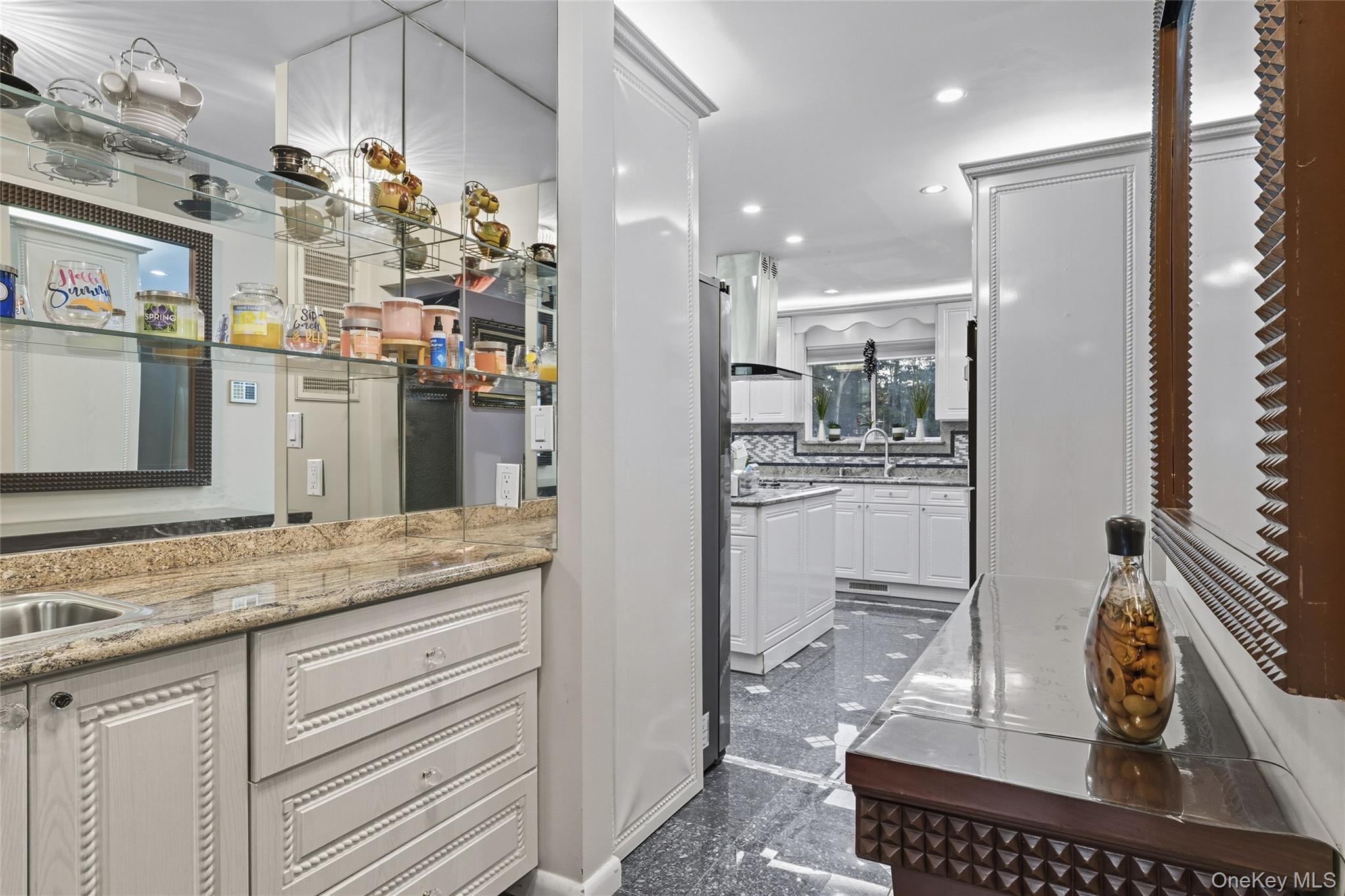 258 Half Hollow Road Dix Hills, NY 11746 - Photo 33 of 45 a kitchen with kitchen island granite countertop a refrigerator oven a sink and white cabinets