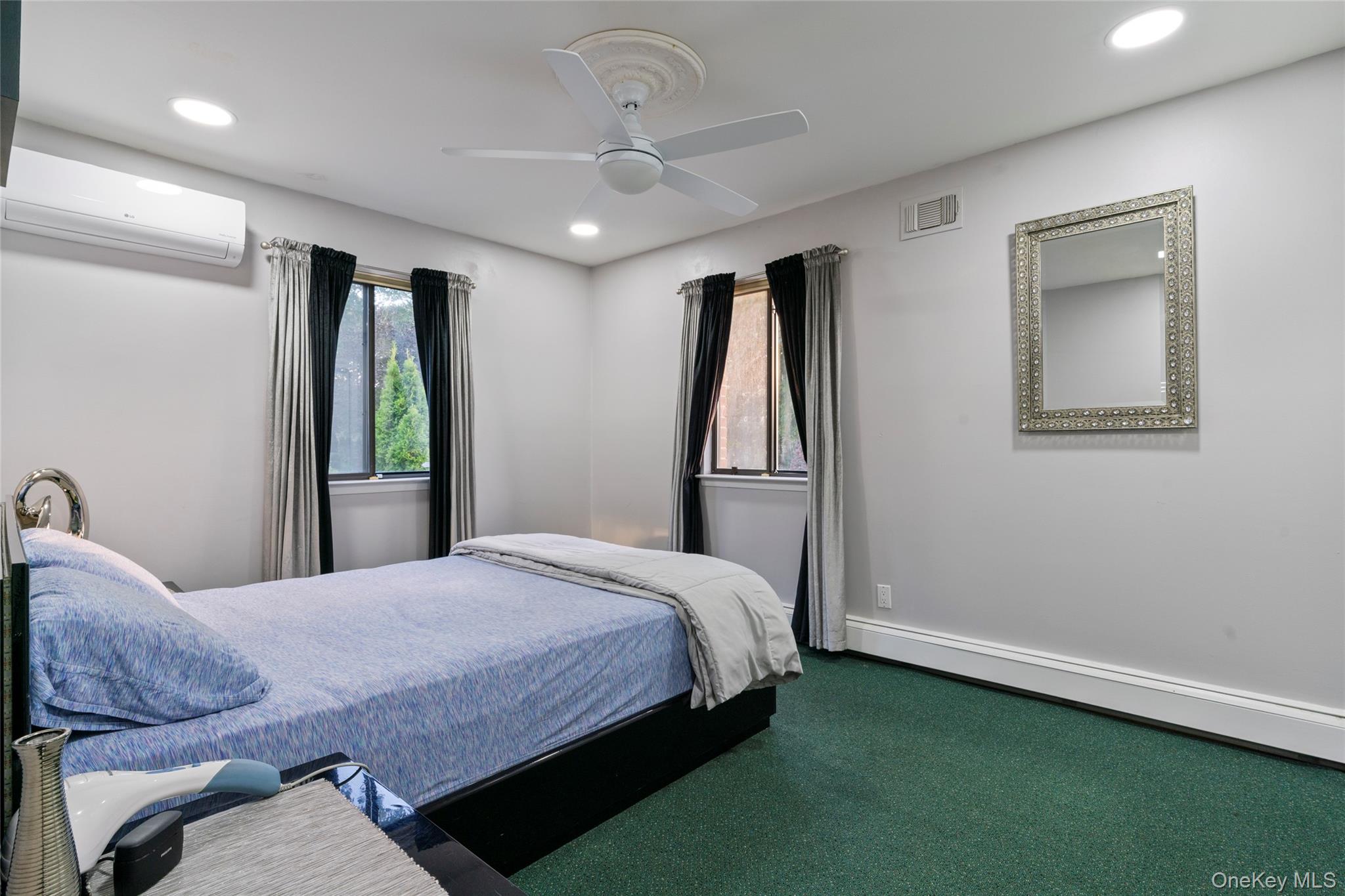 258 Half Hollow Road Dix Hills, NY 11746 - Photo 34 of 45 a bedroom with a bed and a chandelier