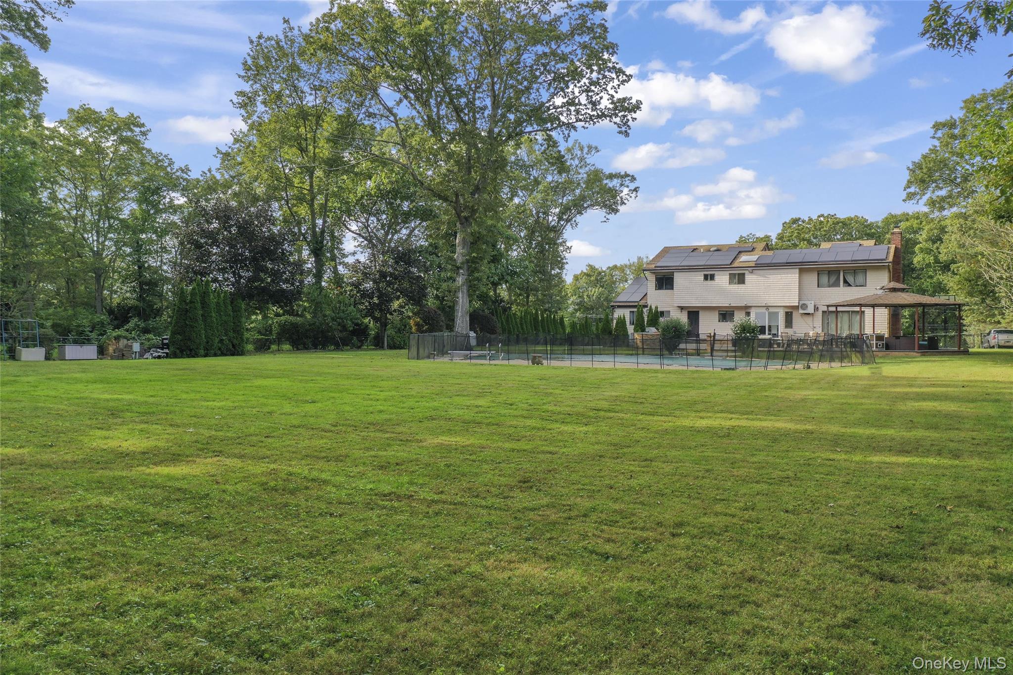 258 Half Hollow Road Dix Hills, NY 11746 - Photo 9 of 45 a view of a green field with house in the background