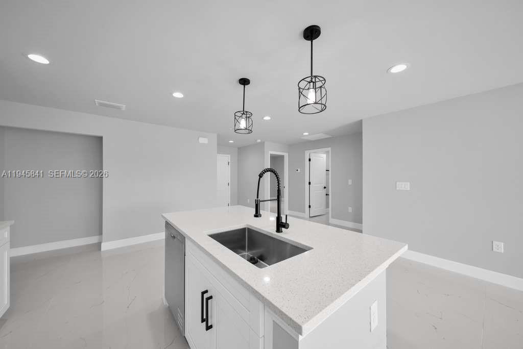 3210 10th Street Southwest, Unit 3210 Lehigh Acres, FL 33976 - Photo 13 of 29 a kitchen with a sink a counter space and cabinets