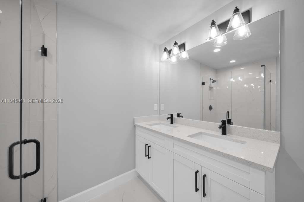 3210 10th Street Southwest, Unit 3210 Lehigh Acres, FL 33976 - Photo 19 of 29 a bathroom with a double vanity sink a mirror and vanity