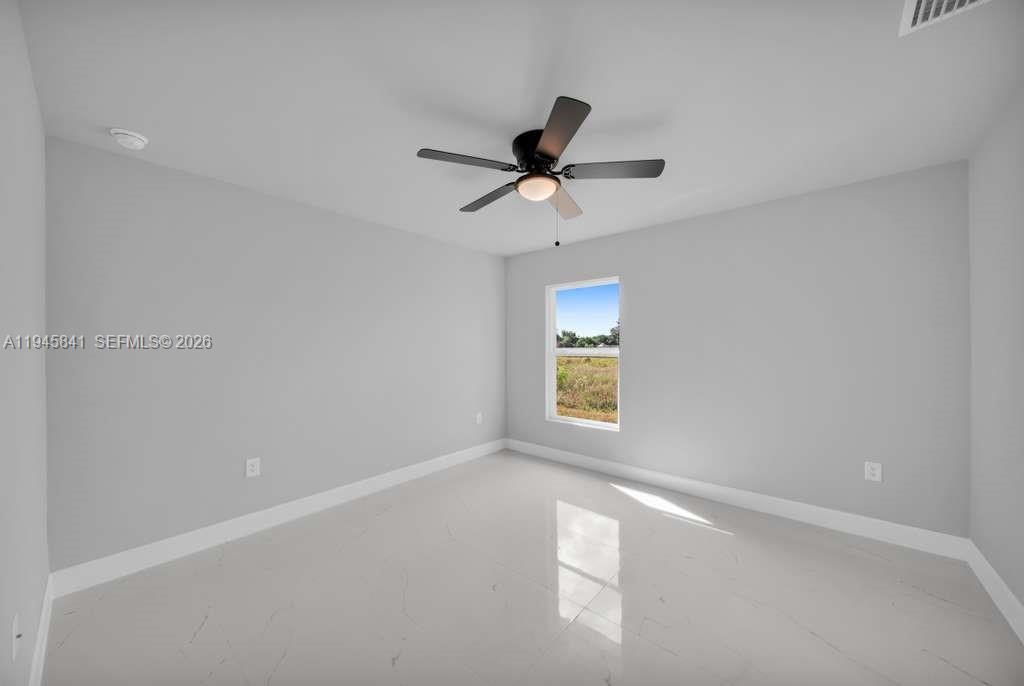 3210 10th Street Southwest, Unit 3210 Lehigh Acres, FL 33976 - Photo 23 of 29 a view of an empty room and a window