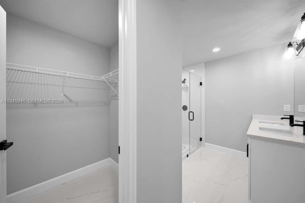 3210 10th Street Southwest, Unit 3210 Lehigh Acres, FL 33976 - Photo 24 of 29 a bathroom with a sink and a shower