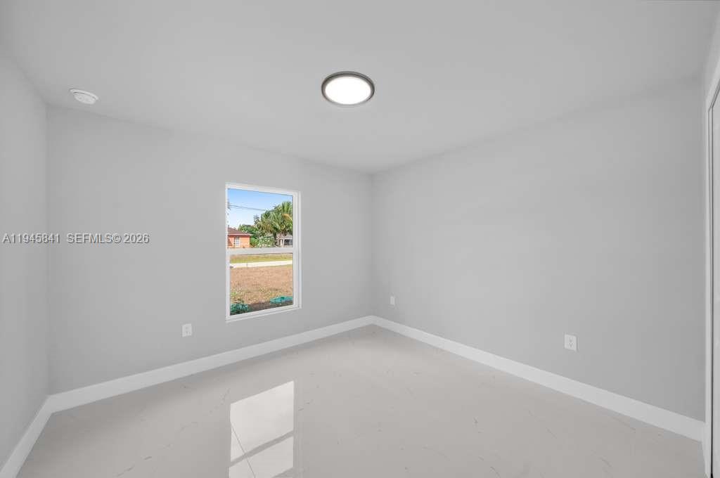 3210 10th Street Southwest, Unit 3210 Lehigh Acres, FL 33976 - Photo 26 of 29 a view of an empty room with a window