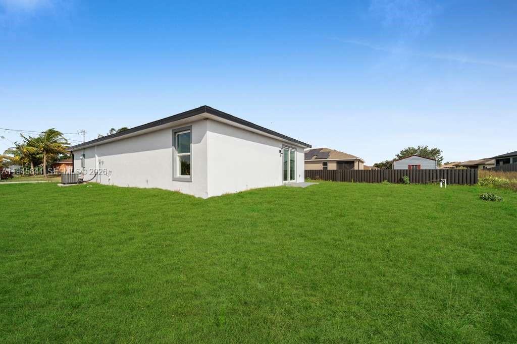 3210 10th Street Southwest, Unit 3210 Lehigh Acres, FL 33976 - Photo 7 of 29 a view of a house with backyard