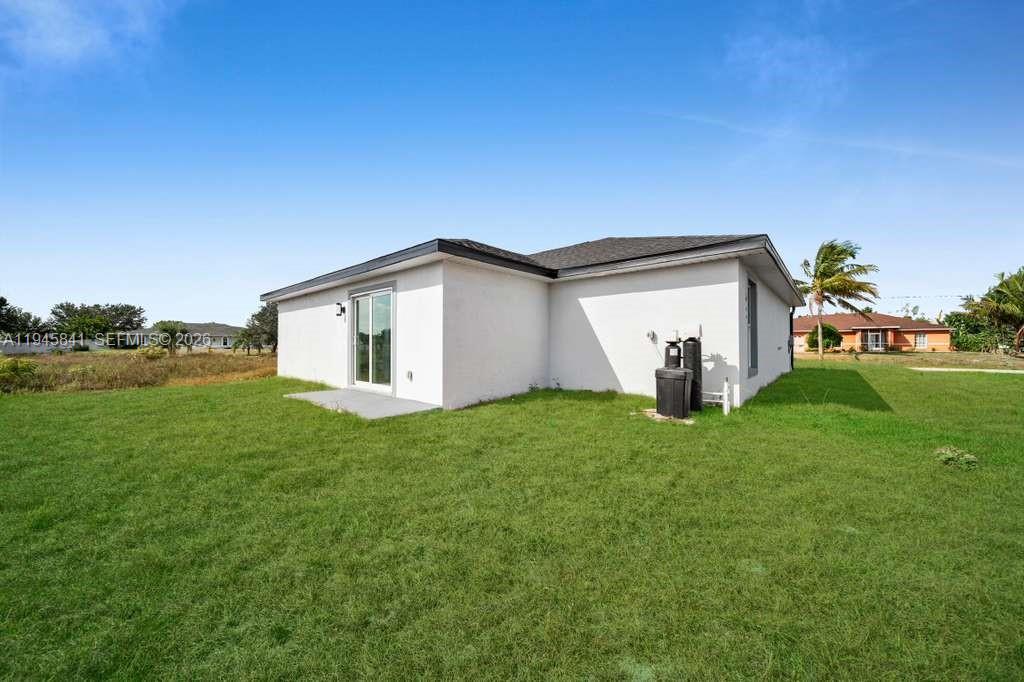 3210 10th Street Southwest, Unit 3210 Lehigh Acres, FL 33976 - Photo 8 of 29 a view of a house with backyard