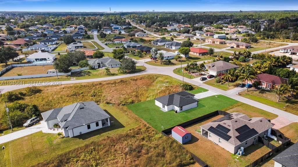 3210 10th Street Southwest, Unit 3210 Lehigh Acres, FL 33976 - Photo 9 of 29 an aerial view of a house with a swimming pool