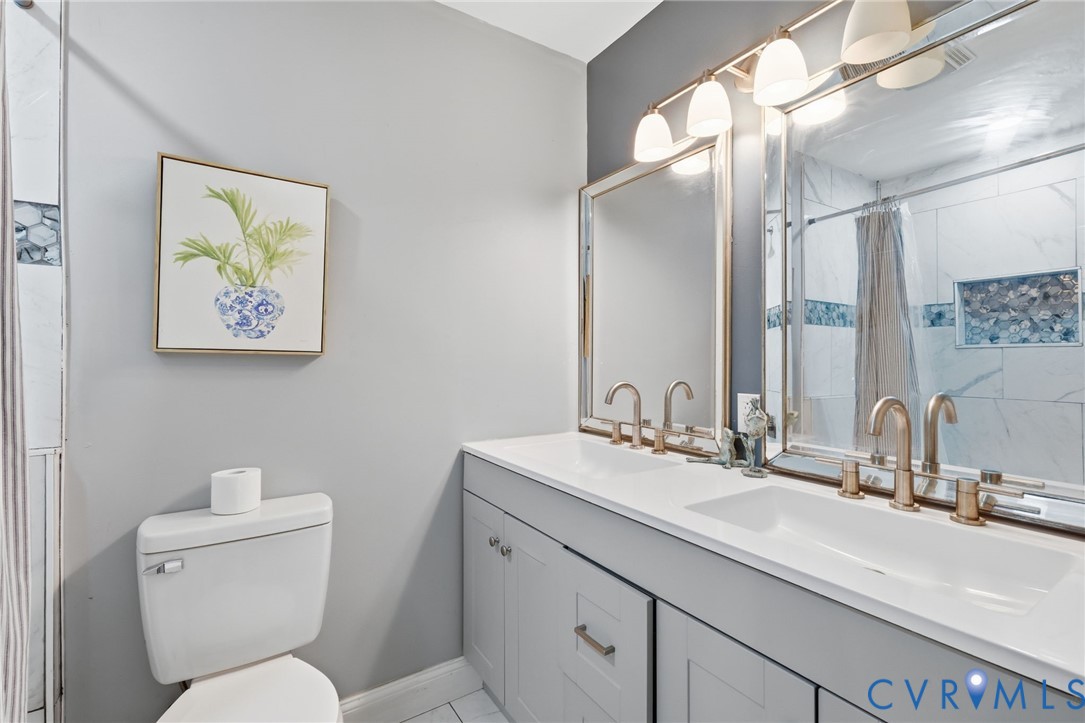 102 Spring Street Petersburg, VA 23803 - Photo 16 of 24 Bathroom featuring double vanity and a shower with