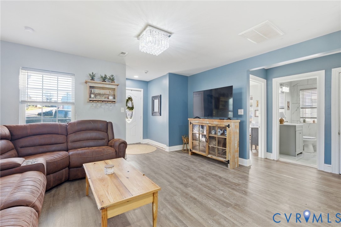 102 Spring Street Petersburg, VA 23803 - Photo 8 of 24 Living room with plenty of natural light, wood fin