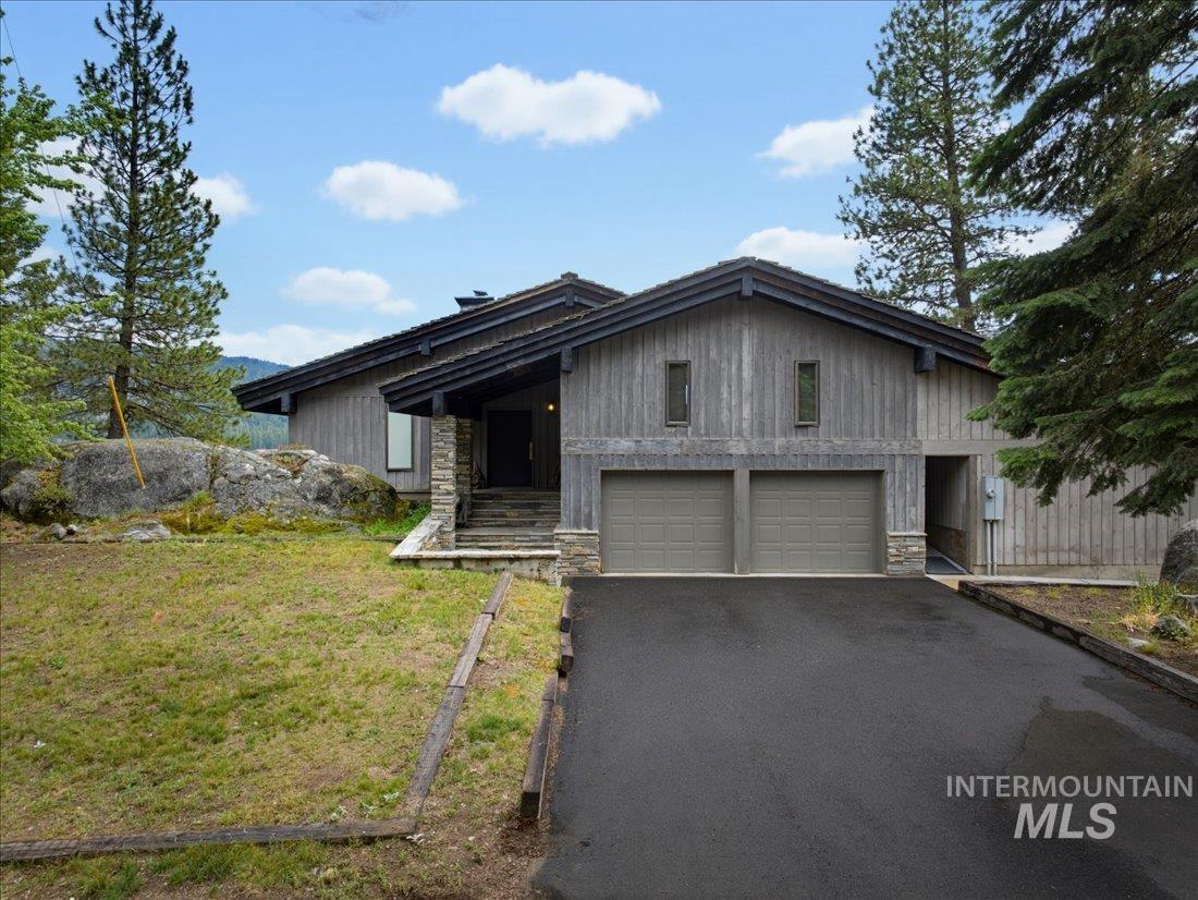 3800 Warren Wagon Road McCall, ID 83638 - Photo 48 of 50 Wood-sided exterior with stone accents and a multi-car garage