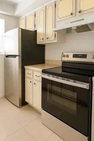 a kitchen with stainless steel appliances granite countertop a refrigerator and a stove