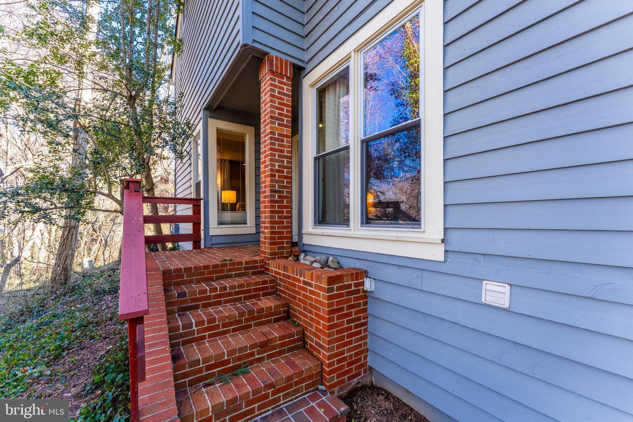 1609 Apricot Court Reston, VA 20190 - Photo 4 of 56 a front view of a house with a garden
