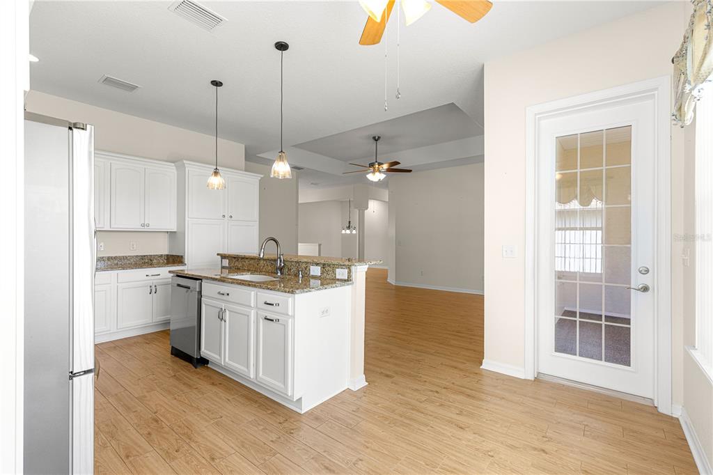 17306 Southeast 112th Court Road Summerfield, FL 34491 - Photo 12 of 42 a large kitchen with a stove a sink dishwasher and a refrigerator