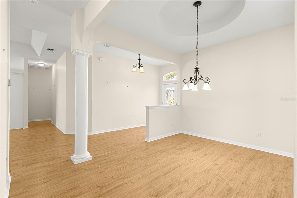 17306 Southeast 112th Court Road Summerfield, FL 34491 - Photo 16 of 42 a view of empty room with wooden floor and ceiling fan