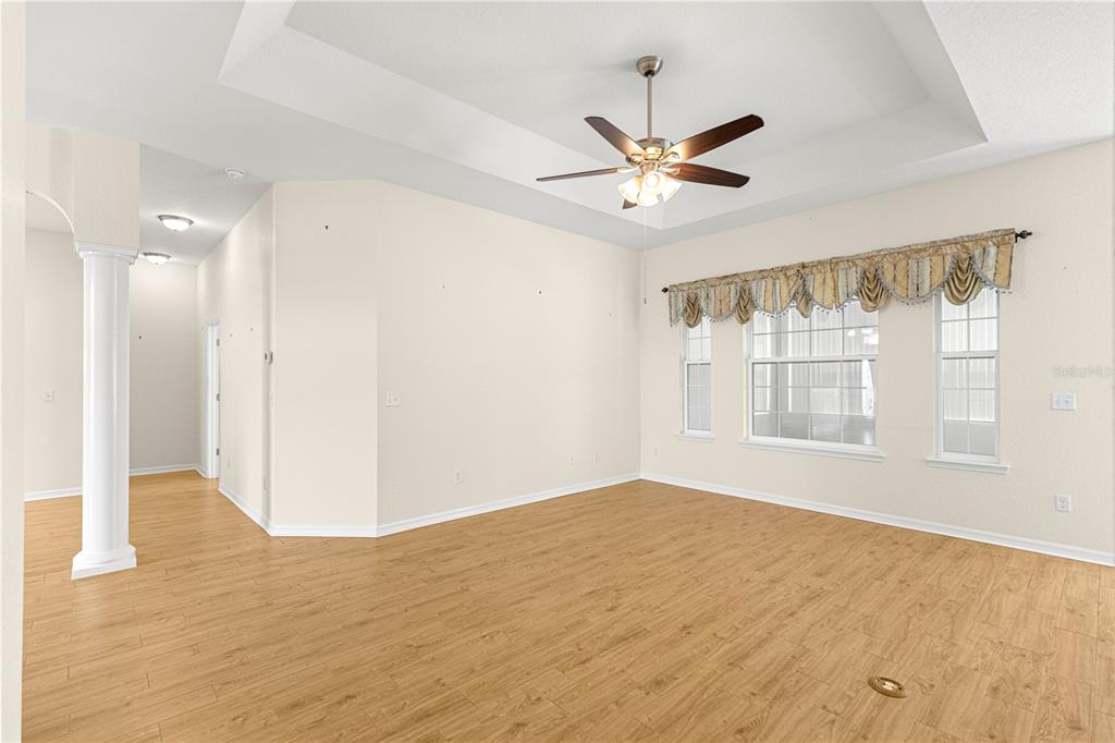 17306 Southeast 112th Court Road Summerfield, FL 34491 - Photo 18 of 42 a view of an empty room with wooden floor and a window