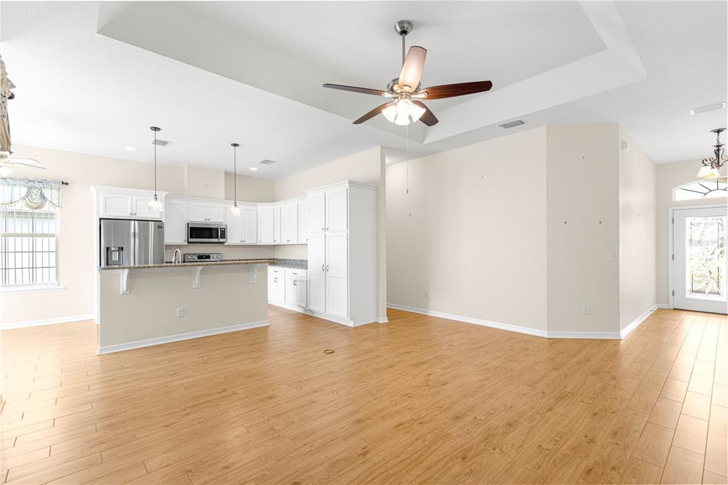 17306 Southeast 112th Court Road Summerfield, FL 34491 - Photo 20 of 42 a view of kitchen with wooden floor and window