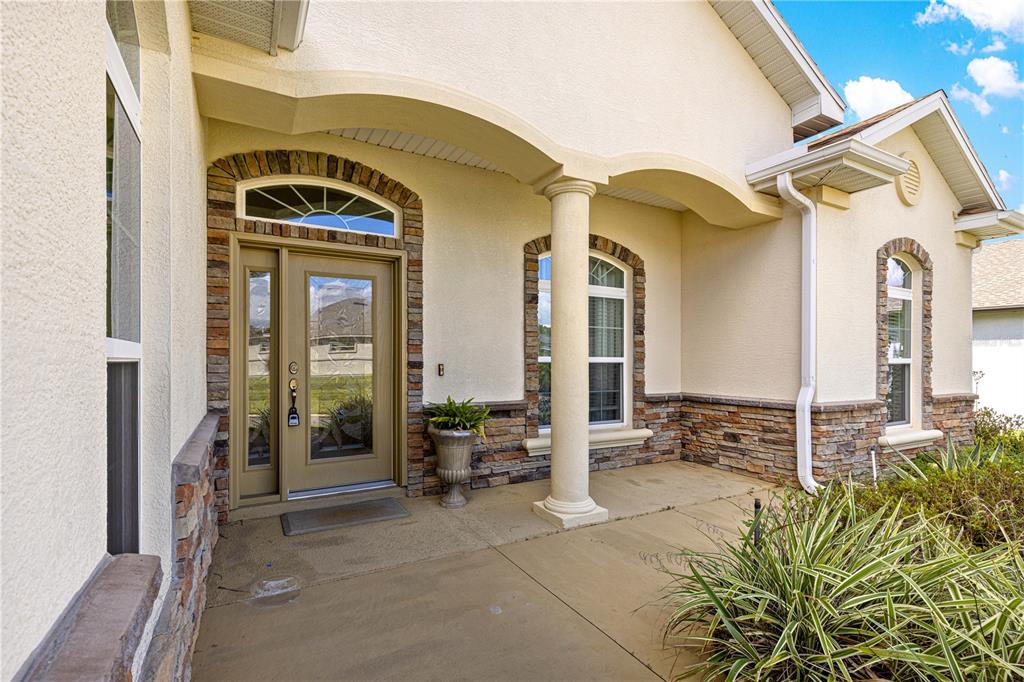 17306 Southeast 112th Court Road Summerfield, FL 34491 - Photo 2 of 42 a front view of a house with outdoor seating