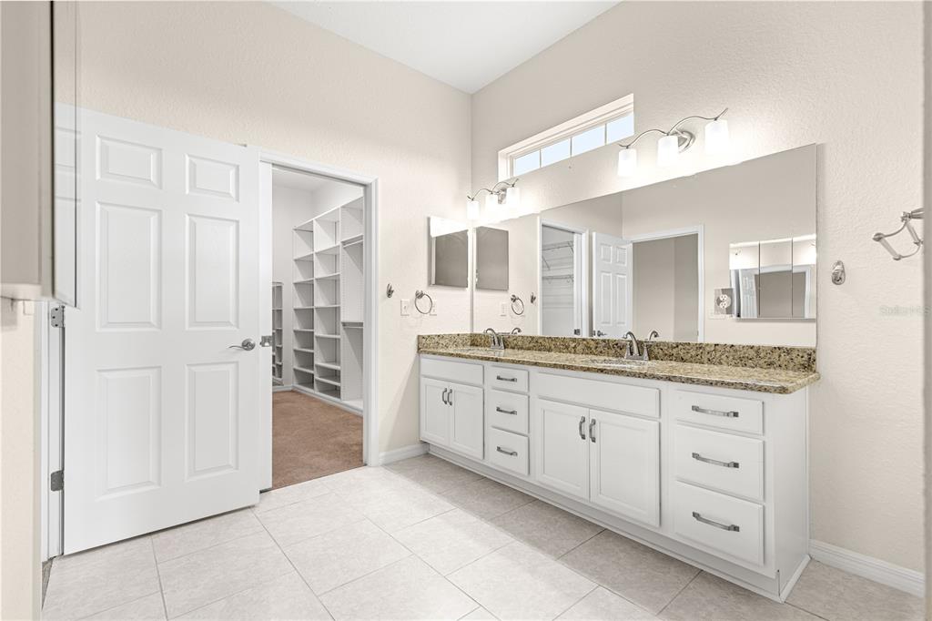 17306 Southeast 112th Court Road Summerfield, FL 34491 - Photo 24 of 42 a spacious bathroom with a granite countertop sink mirror and a