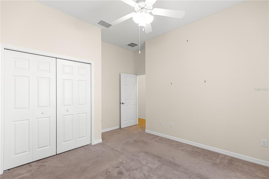 17306 Southeast 112th Court Road Summerfield, FL 34491 - Photo 29 of 42 an empty room with a fan & a ceiling fan