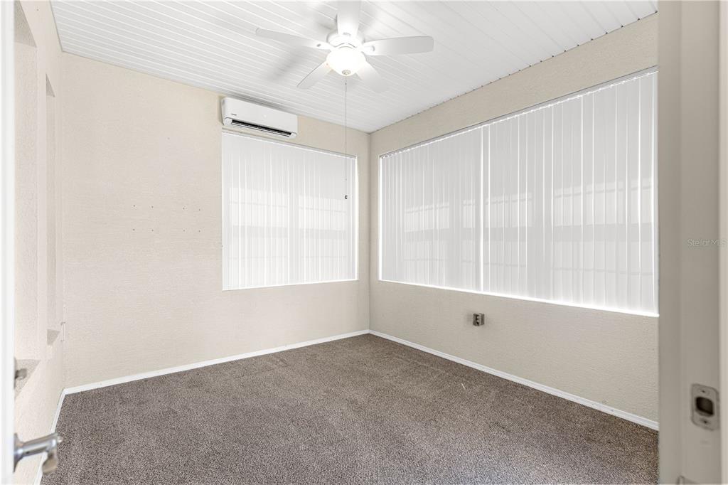 17306 Southeast 112th Court Road Summerfield, FL 34491 - Photo 31 of 42 an empty room with a window and a fan