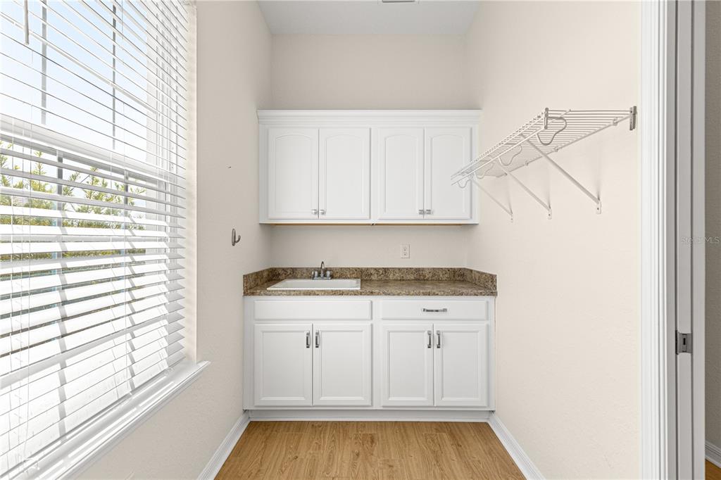 17306 Southeast 112th Court Road Summerfield, FL 34491 - Photo 35 of 42 a view of a kitchen with a sink cabinets and wooden floor