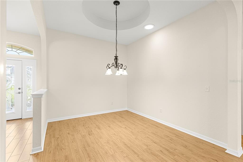 17306 Southeast 112th Court Road Summerfield, FL 34491 - Photo 4 of 42 a view of a room with wooden floor and fan