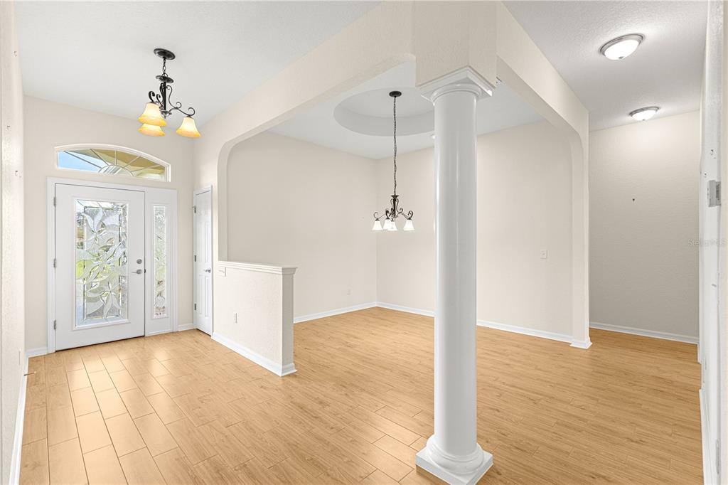 17306 Southeast 112th Court Road Summerfield, FL 34491 - Photo 5 of 42 a view of an empty room with window and wooden floor