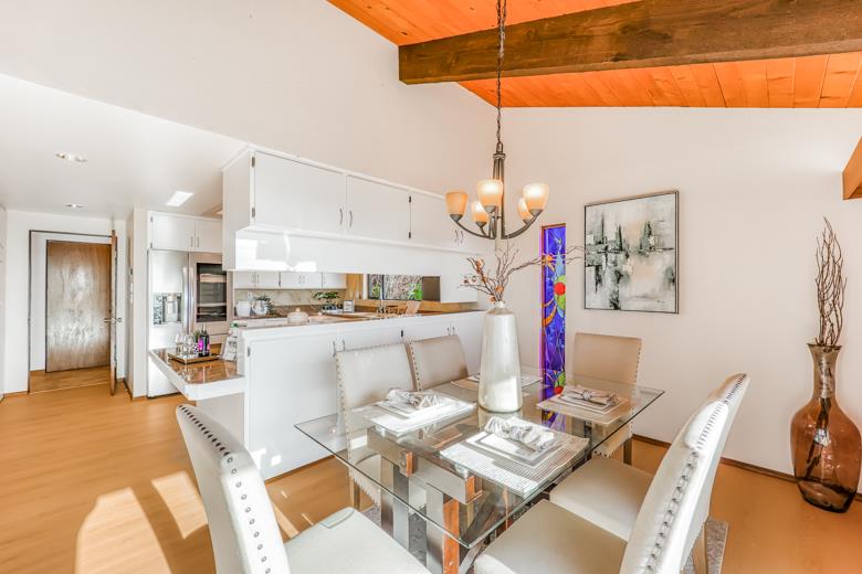 11 Senior Avenue Berkeley, CA 94708 - Photo 8 of 38 a living room with kitchen island furniture and a chandelier