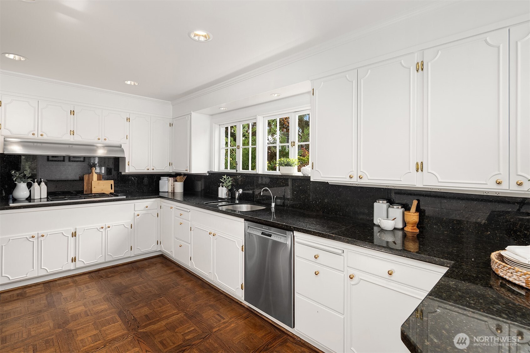 5525 Northeast Penrith Road Seattle, WA 98105 - Photo 14 of 36 a kitchen with granite countertop white cabinets and white appliances