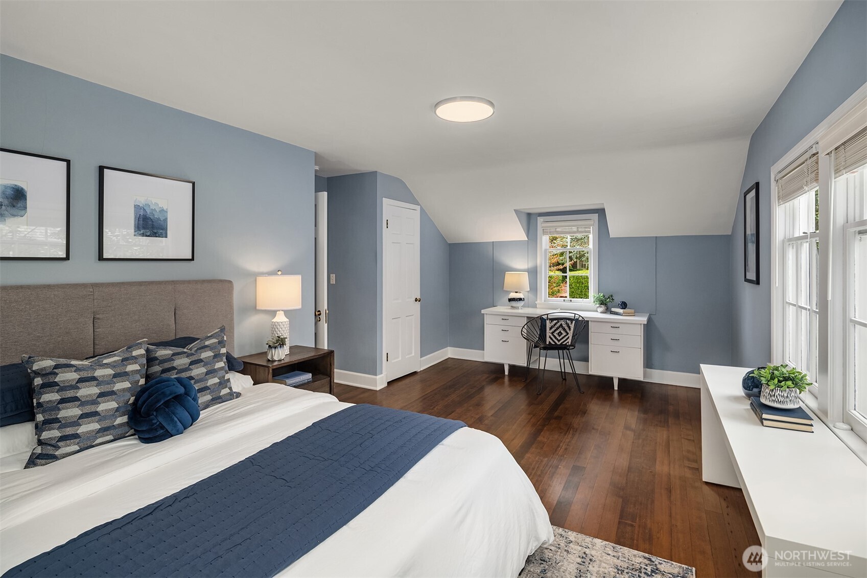 5525 Northeast Penrith Road Seattle, WA 98105 - Photo 23 of 36 a bedroom with a bed and a wooden floor