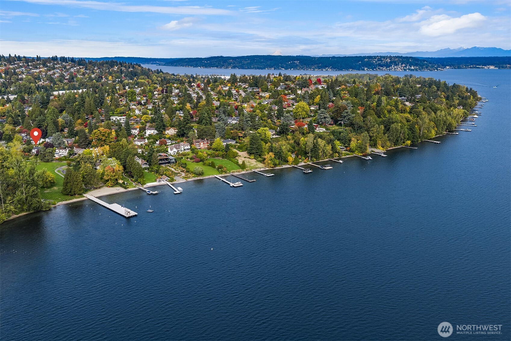 5525 Northeast Penrith Road Seattle, WA 98105 - Photo 36 of 36 a view of a lake with a floor to ceiling window and an outdoor space