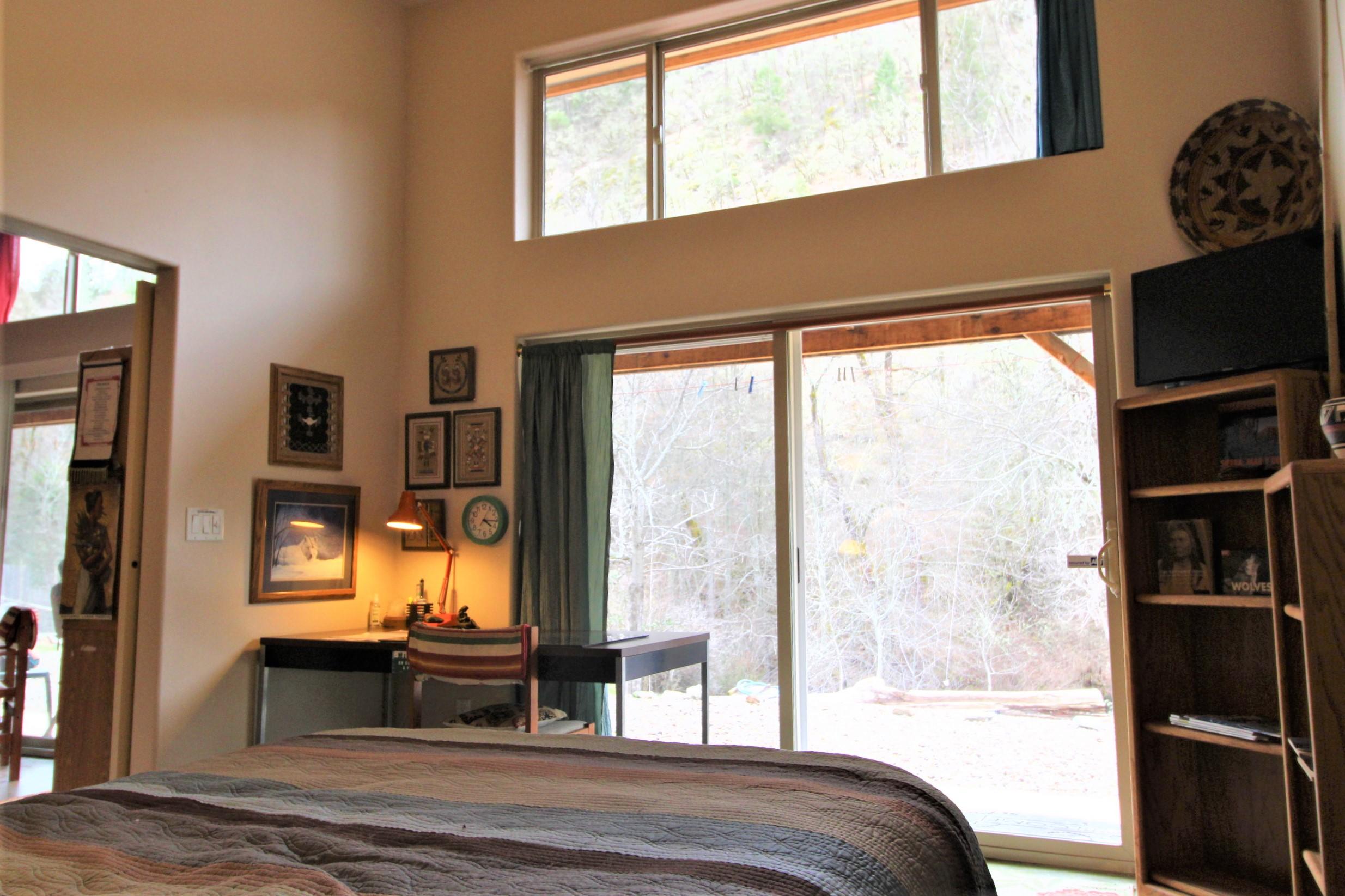 2200 Little Applegate Road Jacksonville, OR 97530 - Photo 19 of 39 a bedroom with furniture and large window