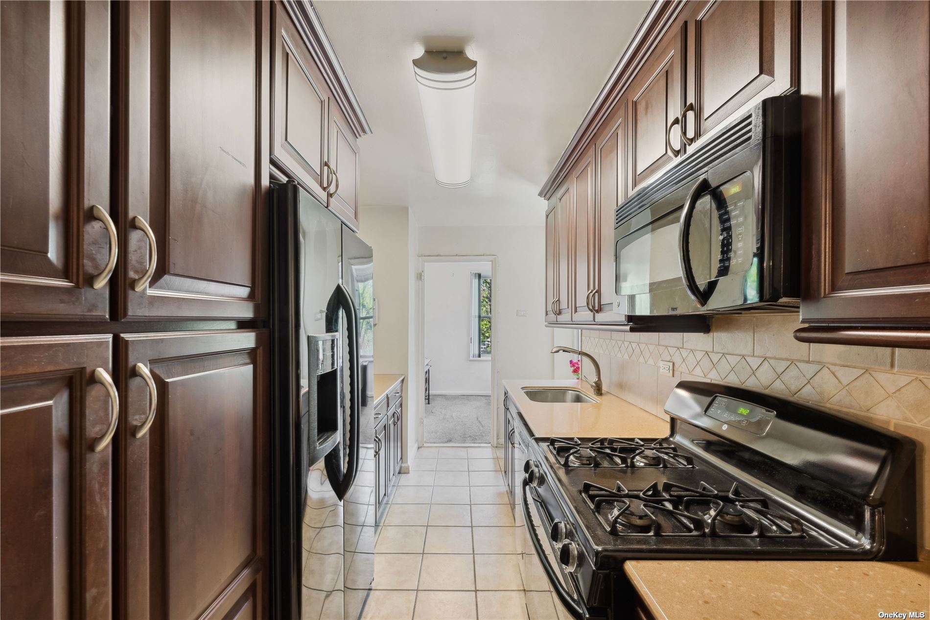 a kitchen with stainless steel appliances granite countertop a stove a refrigerator and a microwave