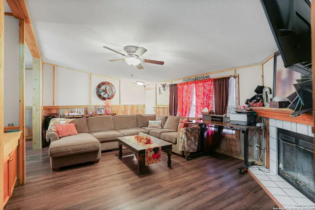 a living room with furniture a fireplace and a flat screen tv