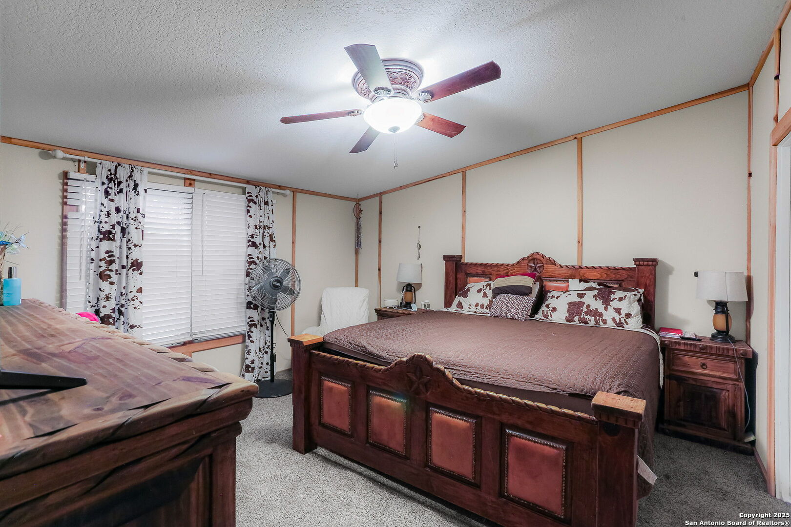 12925 Luckey Road Atascosa, TX 78002 - Photo 18 of 50 a bedroom with a bed and a chandelier