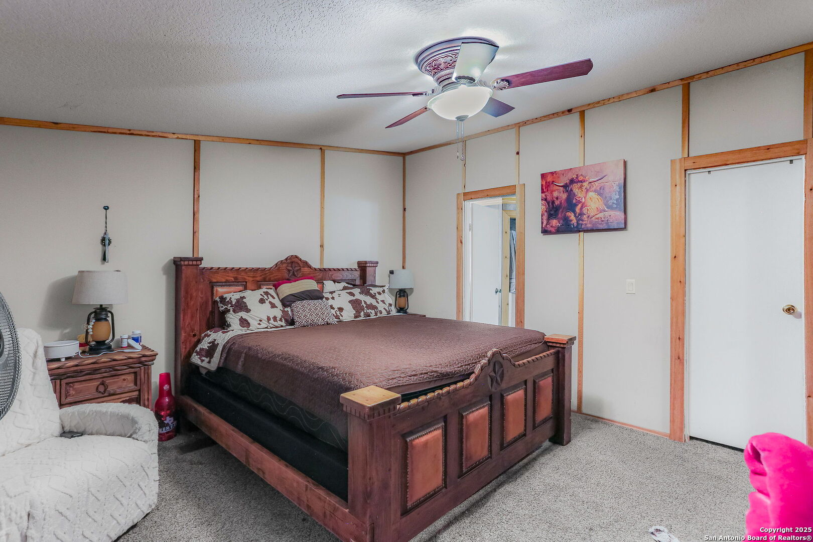 12925 Luckey Road Atascosa, TX 78002 - Photo 19 of 50 a bedroom with a bed and a chandelier