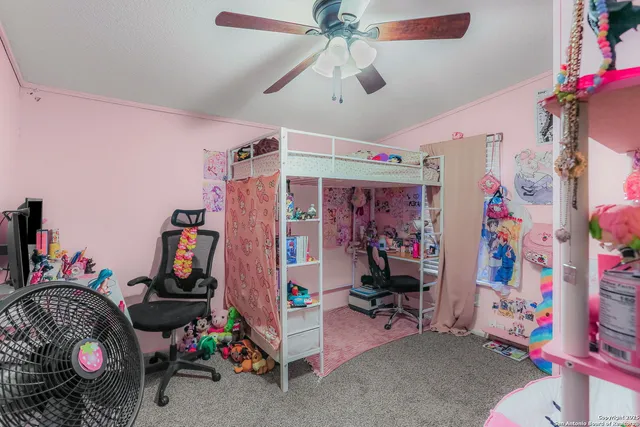 a bedroom with bed and a chandelier